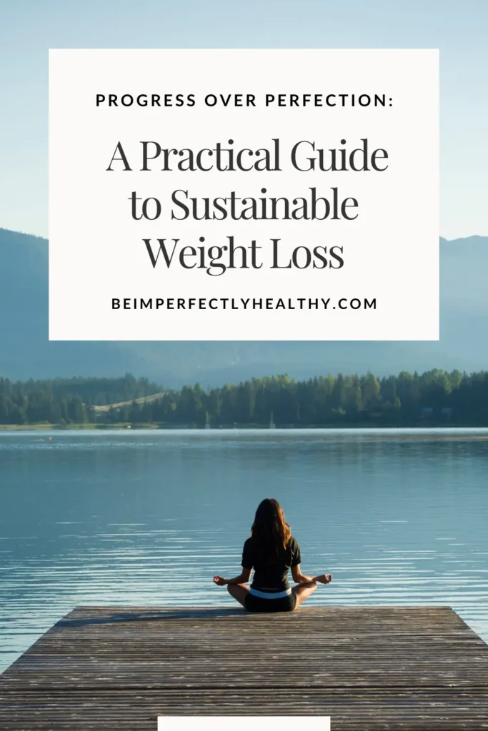 a view of a woman sitting crosslegged on a jetty and the mountians and lake beyond