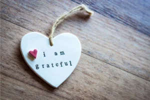 a small heart with the words "I am grateful" etched into it