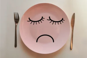 a plate with a sad face painted on it