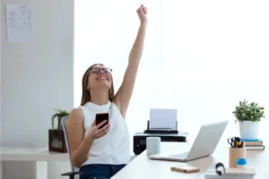 a woman fist pumping in the office